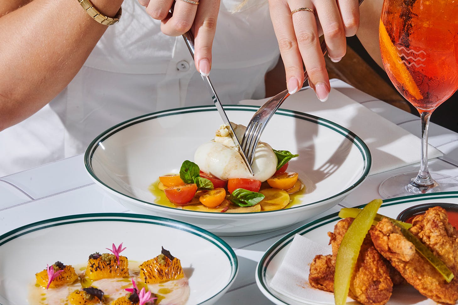 Three plates of food with aperol